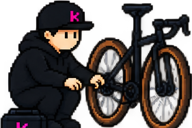 Rider crouched, fixing a bike chain with a toolbox.
